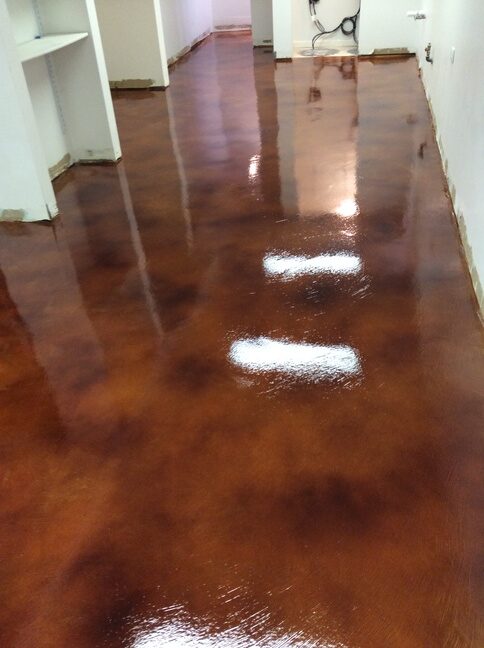 The flooring utilizes a two-color water-based sealer, offering a vibrant and cohesive look throughout.